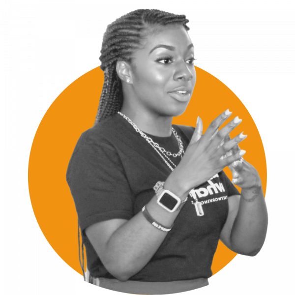 Young woman looking to her left as she speaks and provides emphasis with her hands.